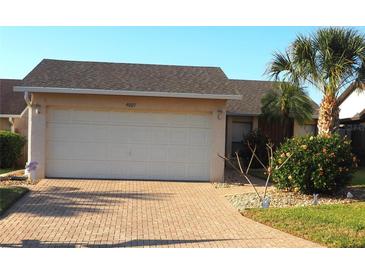 Charming single-Gathering home with brick driveway and lush landscaping at 4007 Cypress Lndg S, Winter Haven, FL 33884