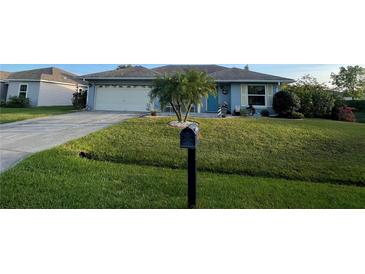 Charming single-story home features a well-maintained front yard, a garage, and a mailbox at 716 Maderia Ct, Kissimmee, FL 34758