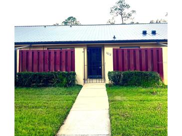 Charming single-story home featuring a well-manicured lawn and a secure gated entrance at 1012 Medinah Dr, Winter Haven, FL 33884