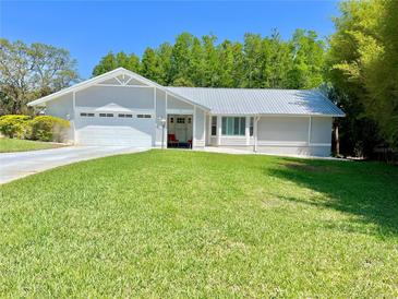 Charming single Gathering home with a well manicured lawn and two-car garage at 14 Cypress Run, Haines City, FL 33844