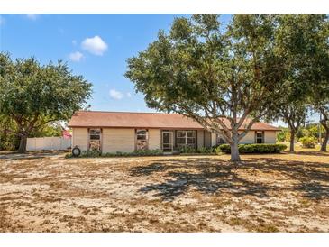 Charming one-story home featuring a spacious yard and beautiful mature trees providing ample shade at 211 Pierce St, Lake Wales, FL 33859