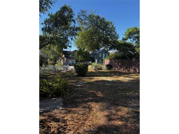 Charming homes nestled among mature trees offer curb appeal on a bright, sunny day at 229 Ne Avenue B, Winter Haven, FL 33881