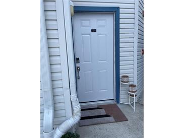 Inviting condo front door with a digital lock and a blue trim at 2516 Woodgate Blvd # 205, Orlando, FL 32822