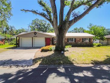 Charming single-story home featuring a two-car garage and a vibrant red front door at 2640 Handley Blvd, Lakeland, FL 33803
