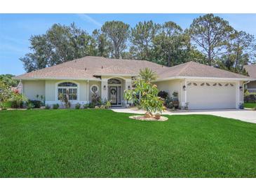 Charming single-story home with a well-maintained lawn, mature landscaping, and a welcoming two-car garage at 3158 Beauchamp Ct, Winter Haven, FL 33884