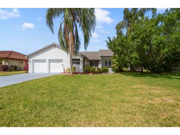 Beautiful single Gathering home showcasing lush green lawn and an attached two car garage at 6014 Crystal View Dr, Orlando, FL 32819