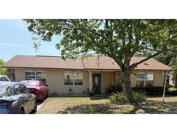 Charming single-story home featuring manicured lawn, mature trees, and well-maintained landscaping at 808 Ware Ne Ave, Winter Haven, FL 33881