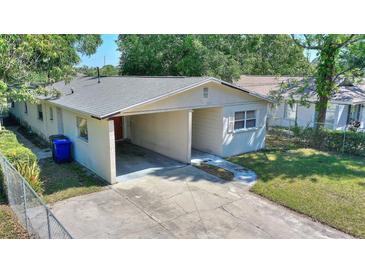 Cozy single story home featuring a carport and a well-maintained front yard at 825 Augusta St, Lakeland, FL 33805