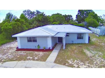 Charming single-story home with a metal roof, freshly painted exterior and landscaped front yard at 101 Babson Heights Dr, Babson Park, FL 33827
