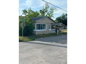 Modest single-story home with neutral siding, surrounded by trees at 217 Nw 4Th Ave, Mulberry, FL 33860