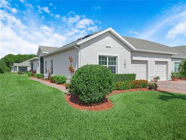Charming villa featuring a well-manicured lawn and beautiful landscaping at 2824 Attwater Loop, Winter Haven, FL 33884