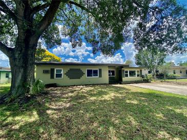 Charming single story home with a large tree in the front yard and driveway at 3022 Hickory Nw St, Winter Haven, FL 33881