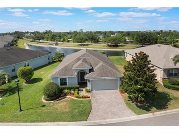Beautiful single-story home with a well-manicured lawn and a serene pond view in a lovely community at 3844 Bedford Ave, Winter Haven, FL 33884
