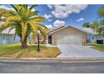 Charming single-story home with a well-manicured lawn and a two-car garage at 492 Sweetwater Way, Haines City, FL 33844
