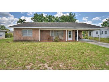 Charming brick home featuring a covered front porch and carport for convenient parking at 780 Oleander Se Dr, Winter Haven, FL 33880
