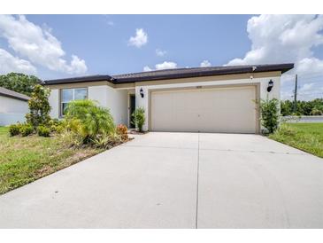 Charming one-story home featuring an attached two car garage and freshly landscaped yard at 1050 Michelangelo Ln, Winter Haven, FL 33884