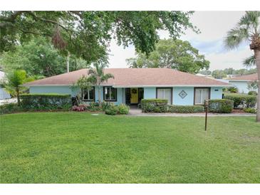 Beautiful one-story home boasts lush green grass and landscaping at 255 Lake Link Rd, Winter Haven, FL 33884