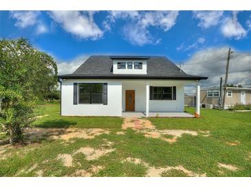 Charming renovated house with a new roof, landscaping, and a classic, inviting facade at 1042 Golden Bough Rd, Lake Wales, FL 33898
