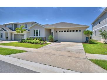 Charming single-story home with manicured lawn and a two-car garage at 1100 Sugarwood St, Davenport, FL 33837