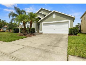 Charming single-Gathering home with well-maintained lawn and landscaping with lovely palm trees at 151 Hideaway Beach Ln, Kissimmee, FL 34746