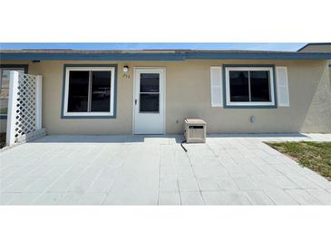 Charming single-story home with a welcoming front entrance and neutral-colored exterior with a concrete patio at 254 Winter Ridge Blvd # 254, Winter Haven, FL 33881