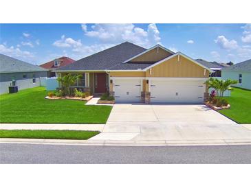 Charming single-story home with a two-car garage, well-manicured lawn, and delightful landscaping at 421 Riders Loop, Auburndale, FL 33823