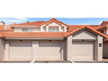 Three-car garage exterior showing numbered units with terra cotta tile roof at 703 Magnolia Pl # 703, Winter Haven, FL 33884