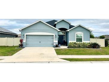 Charming single-story home featuring a two-car garage, well-manicured lawn, and inviting front entrance at 832 Vienna Dr, Winter Haven, FL 33884