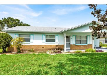 Charming single-story home featuring a well-maintained lawn and colorful landscaping at 109 Dakota Ave, St Cloud, FL 34769