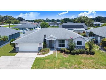 Charming single-story home with well-maintained landscaping, stone accents, and a two-car garage at 114 Belmont Dr, Winter Haven, FL 33884