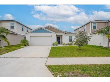 Charming single-story home with a well-manicured lawn and a two-car garage, complete with beautiful landscaping at 1719 Durden Dr, Winter Haven, FL 33880
