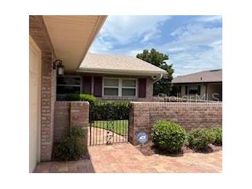 Charming single-story home with brick paved walkway and gated courtyard at 381 Troon Ct, Winter Haven, FL 33884