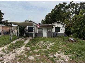 Modest single Gathering home featuring a carport and front lawn, in need of some TLC at 803 26Th Nw St, Winter Haven, FL 33881