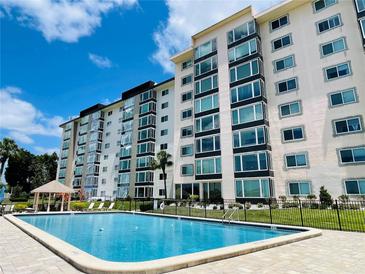 Resort-style pool with inviting blue water in front of a well-maintained condominium building at 1776 6Th Street Nw # 709, Winter Haven, FL 33881