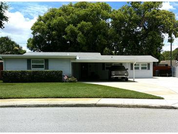 Charming single story home with a well-maintained lawn and covered parking at 2021 Oliver Pl, Winter Haven, FL 33881