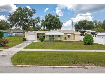 Charming single story home with well manicured lawn, attached garage, and covered front porch at 304 W Lake Ave, Auburndale, FL 33823