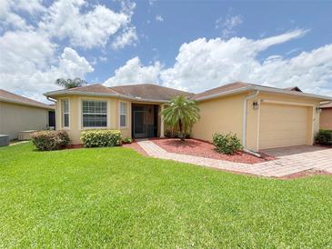 Charming single-story home with well-maintained landscaping and a brick walkway at 4469 Turnberry Ln, Lake Wales, FL 33859