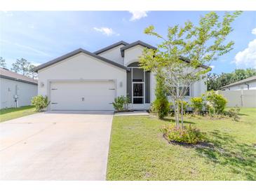 Charming single Gathering home featuring a well maintained lawn and two car garage at 6300 Dolostone Dr, Lakeland, FL 33811