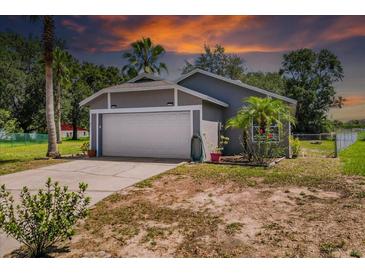 Charming single-story home with a two-car garage and lush landscaping at 1100 Lowry Ave # 63, Lakeland, FL 33801