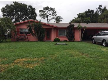 Charming single-story home featuring lush green lawn and mature trees for shade and curb appeal at 1811 5Th Se St, Winter Haven, FL 33880