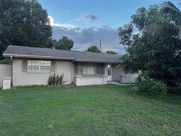 Charming single-story brick home featuring a well-maintained lawn and mature landscaping at 2800 Sunset Nw Dr, Winter Haven, FL 33881