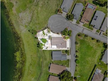 Beautiful aerial view of lakefront property with manicured landscaping and mature trees at 452 Lake Suzanne Dr, Lake Wales, FL 33859