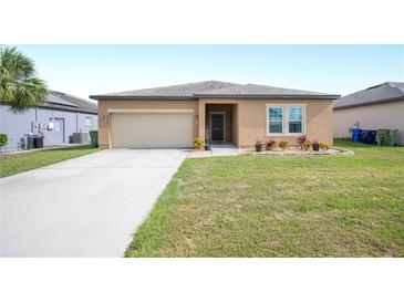 Well-maintained front yard featuring a lush lawn and tidy landscaping at 4662 Osprey Way, Winter Haven, FL 33881