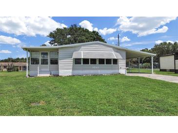 Charming single-story home with a well-manicured lawn and covered parking at 1548 Longbow Dr, Lakeland, FL 33810