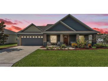 Charming single-Gathering home with beautiful landscaping, covered porch, and attached two car garage at 195 Kissengen Park Blvd, Bartow, FL 33830