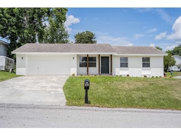 Charming, renovated one-story home featuring a new roof and white painted brick exterior with tidy front yard at 4921 Sharon Ave, Lakeland, FL 33812