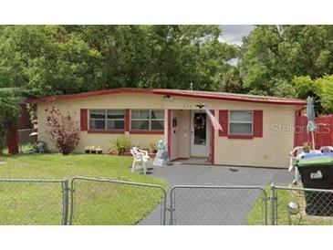 Charming single-story home featuring a well-maintained front yard and cozy curb appeal at 919 Timor Ave, Orlando, FL 32804