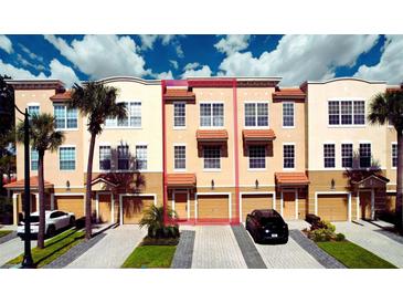 Charming multi-story townhome featuring a private garage, neutral exterior, and well-maintained landscaping at 5002 Tideview Cir # 3, Orlando, FL 32819