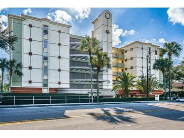 Lake Virginia condo building, featuring attractive architecture and landscaping at 690 Osceola Ave # 308, Winter Park, FL 32789