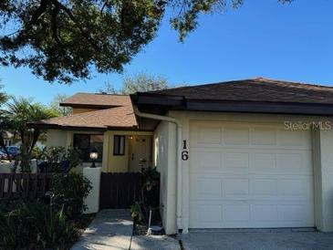 Front view of a condo with attached garage, and well-manicured landscaping at 940 Fenton Ln # 16, Lakeland, FL 33809